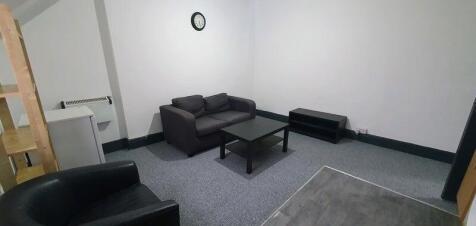 A modern, well-maintained living room featuring...