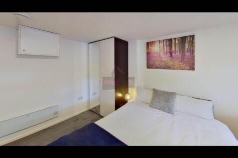 A spacious and comfortably decorated master bed...