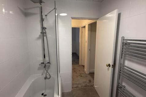 A clean and modern bathroom with a spacious sho...