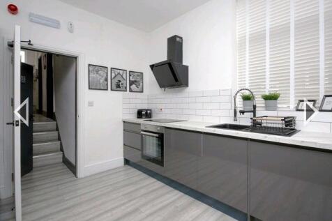 Modern and sleek kitchen with ample counter spa...