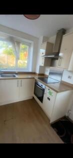 A bright, modern kitchen with a large window pr...