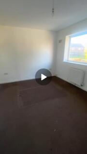 A bright, spacious living room with a large win...
