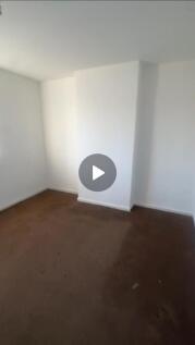A bright, well-maintained bedroom with white wa...