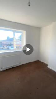 Bright and spacious living room with a large wi...