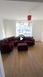 A spacious and bright living room featuring a l...
