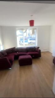 A spacious and inviting living room featuring a...