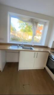Bright and airy kitchen with a large window all...