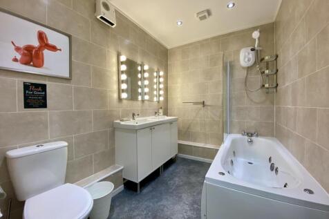 A modern, well-maintained bathroom featuring a ...