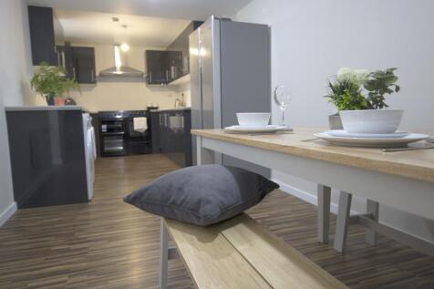 A modern, well-lit kitchen area featuring sleek...