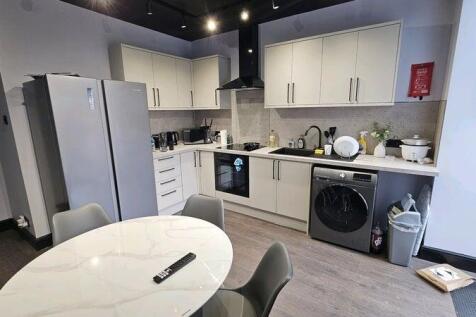 A modern, well-maintained kitchen with sleek wh...