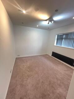 A spacious, well-maintained living room with ne...