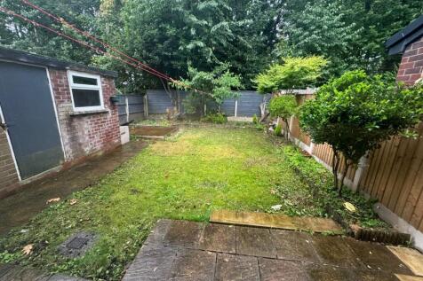 A well-maintained garden area with lush greener...