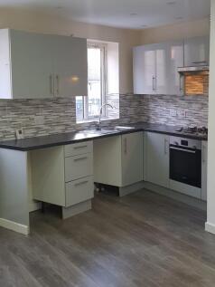 Modern kitchen with ample natural light, featur...