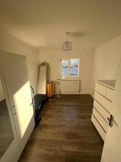 Bright and tidy room with wooden flooring, a wi...