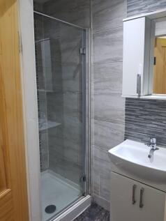 A modern bathroom featuring a shower area with ...