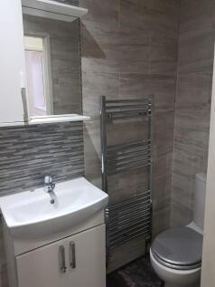 A clean, modern bathroom featuring a sink with ...