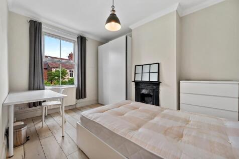 Bright, neatly presented bedroom with a comfort...