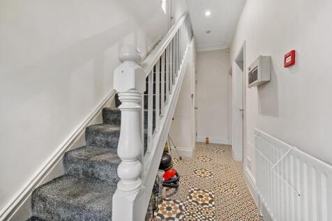 Bright, welcoming hallway with patterned tiled ...