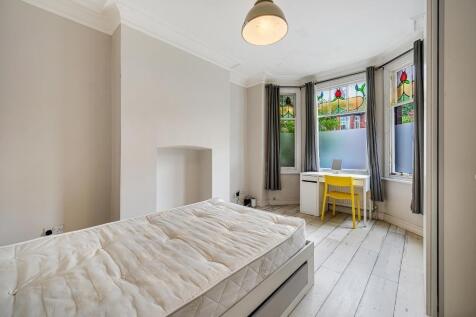 Bright, freshly painted bedroom with period bay...