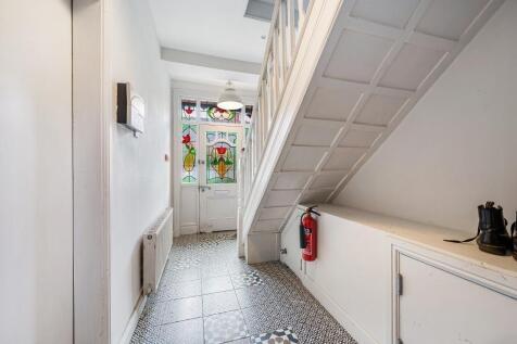 Bright, well-maintained hallway with decorative...