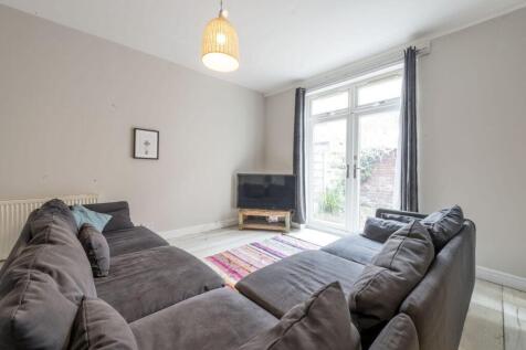 Bright, modern living room with a large L-shape...