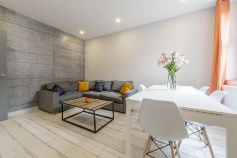 Bright, modern living room with a comfortable g...