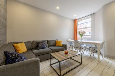 Bright, modern living room with a comfortable g...