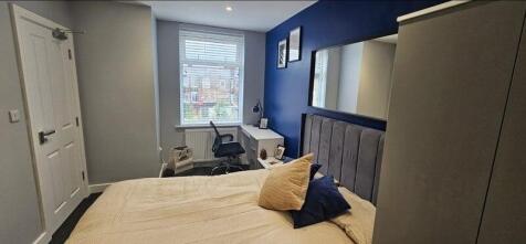 A cozy and modern double bedroom featuring a pl...