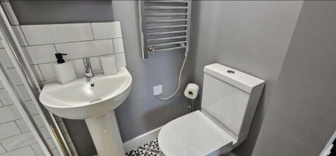 A modern bathroom with a clean white sink and t...