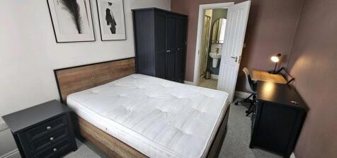 A modern master bedroom with a comfortable doub...