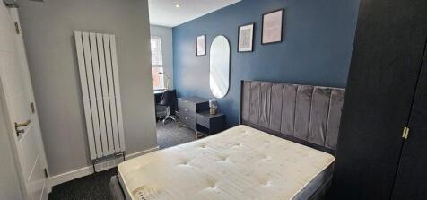 Comfortable double bedroom featuring a modern g...