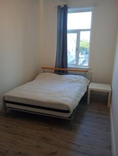 A bright and modern master bedroom featuring a ...