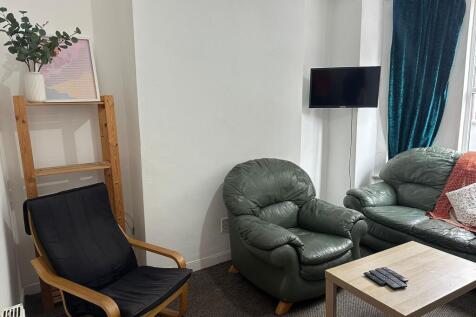 A cozy living room featuring comfortable leathe...