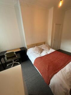 A welcoming double bedroom featuring a comforta...