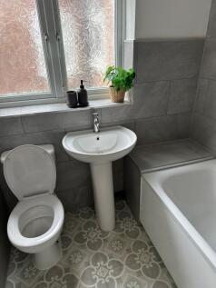 Bright and modern bathroom featuring a large ba...