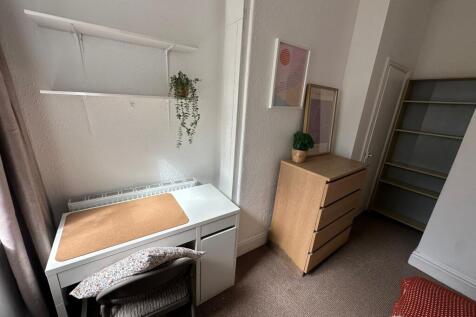 A bright, well-maintained bedroom featuring a s...