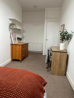 A cozy and well-maintained living room featurin...