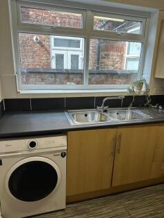 A functional kitchen featuring a dual-basin sta...