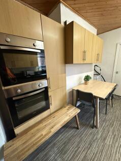 A modern, well-maintained kitchen featuring woo...