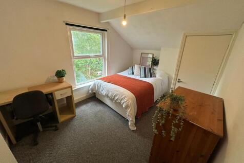 A bright, well-maintained bedroom featuring a c...