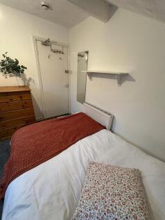 A cozy double bedroom featuring a neatly made b...