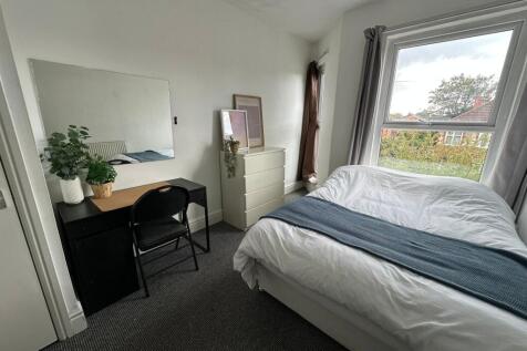 A bright and inviting double bedroom featuring ...