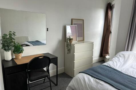 Bright and welcoming master bedroom featuring a...