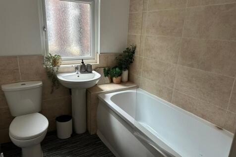 A clean and modern bathroom featuring a white t...