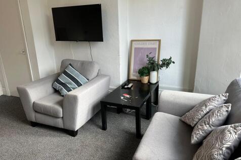 A modern and cozy living room with two comforta...