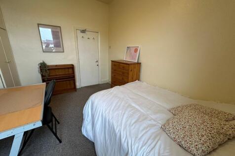 A cozy, well-maintained bedroom featuring a com...