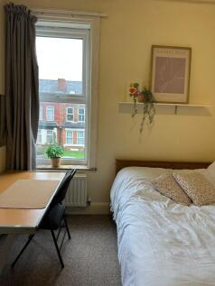 Cozy bedroom with a comfortable bed, illuminate...