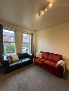 A cozy living room with two comfortable sofas, ...