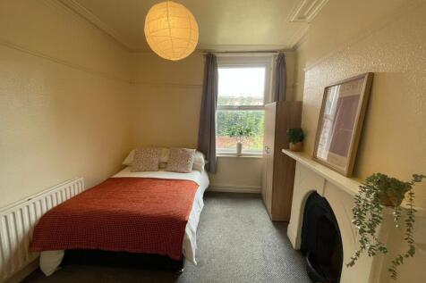 A cozy and well-maintained bedroom featuring a ...