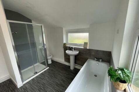 Modern and bright bathroom featuring a spacious...